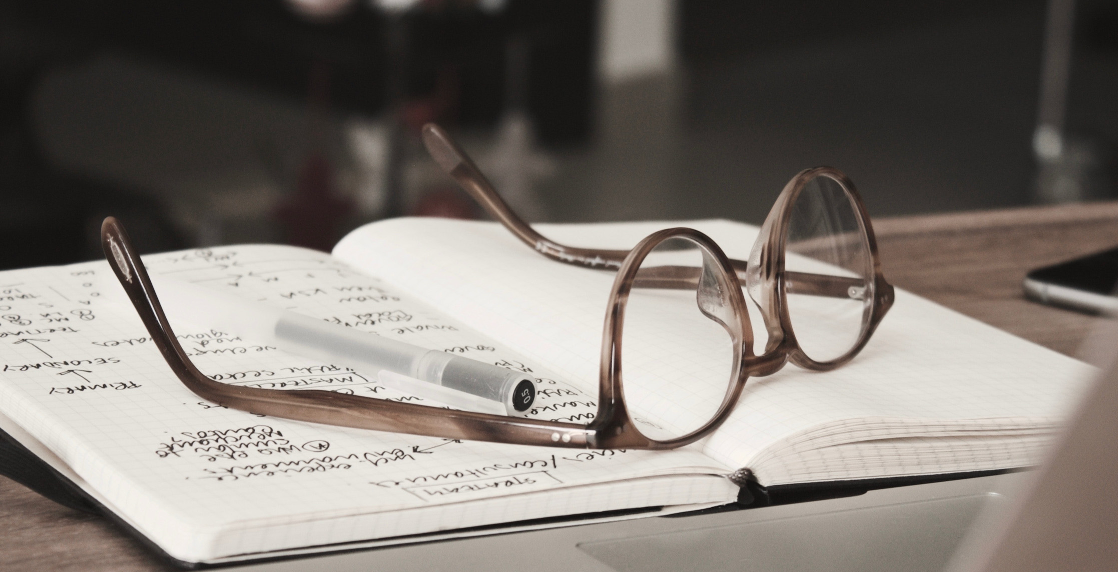 eyeglasses lying on notebook